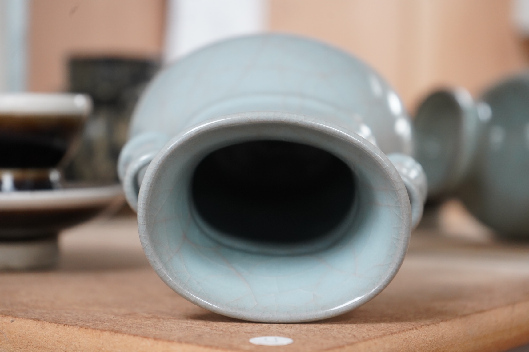 A Chinese crackle glaze arrow vase and a black and russet glazed tea bowl on stand, largest 22cm high